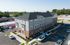 Contemporary multi-story residential building with brick accents, ample parking, and well-maintained landscaping, set in a serene suburban area.