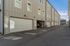 Chic townhouse exterior with modern architectural design, featuring clean lines and spacious garages in a serene neighborhood setting.