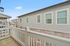 Charming balcony view with a cozy residential exterior and elegant white railings, perfect for enjoying serene neighborhood vibes.
