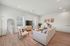 Inviting living room with modern decor, featuring a cozy sofa, elegant armchairs, and stylish wall art, perfect for relaxation and entertaining.