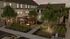 Charming courtyard featuring lush greenery, inviting seating area, and cozy ambiance under evening sky.