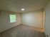Bright and modern room with elegant tile flooring and ample natural light, perfect for a cozy living space.