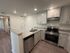 Modern kitchen with granite countertops, stainless steel appliances, and ample storage, perfect for culinary enthusiasts.
