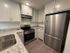 Sleek modern kitchen with stainless steel appliances, white cabinetry, and elegant granite countertops.