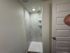 Luxurious modern shower with elegant marble tile and sleek fixtures in a contemporary bathroom setting.