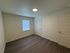 Bright and inviting empty bedroom with sleek hardwood floors and modern design.