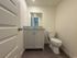 Modern bathroom with elegant vanity, granite countertop, and sleek fixtures.