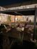 Charming nighttime view of a cozy patio area with Adirondack chairs around a modern fire pit, under a stylish pergola, offering a warm and inviting atmosphere.