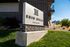 Entrance to Erin Hills Estates featuring brick townhomes and landscaped grounds.