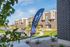 Erin Hills Estates townhomes with a Now Leasing banner and landscaped grounds.