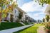Landscaped walkway and green lawns between Erin Hills Estates townhomes.