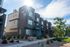 Erin Hills Estates brick townhomes with balconies, patios, and landscaped grounds.