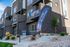 Now Leasing banners displayed outside Erin Hills Estates brick townhomes.