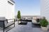 Private rooftop deck with outdoor seating and mountain-sky views at Erin Hills Estates