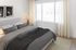 Bedroom with large windows and natural light in an Erin Hills Estates townhome