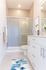 Bathroom with glass walk-in shower and white vanity in an Erin Hills Estates townhome
