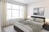 Bright bedroom with large windows in an Erin Hills Estates townhome