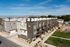Elevated view of modern brick townhomes at Erin Hills Estates with landscaped walkways and mountain views.