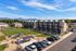 Aerial view of Erin Hills Estates townhomes, green space, playground, pavilion, and mountain views.