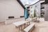 Outdoor patio with picnic tables next to a modern apartment building at The Residences at Victory Ranch in Idaho Falls