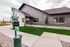 Clubhouse exterior with landscaped lawn and walkway at The Residences at Victory Ranch in Idaho Falls