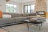 Clubhouse lounge with a sectional sofa by the stone fireplace at The Residences at Victory Ranch in Idaho Falls