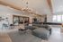 Clubhouse lounge with a sectional sofa and dining tables at The Residences at Victory Ranch in Idaho Falls
