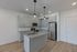 1-bedroom apartment kitchen with island and stainless steel appliances at The Residences at Victory Ranch in Idaho Falls
