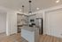 2-bedroom apartment kitchen with island and pendant lights at The Residences at Victory Ranch in Idaho Falls
