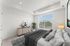 Furnished bedroom with a large picture window and natural light at The Residences at Victory Ranch in Idaho Falls