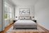 Bright and modern bedroom featuring a comfortable bed, elegant artwork, large window with natural light, and stylish bedside tables.