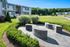 Inviting apartment exterior with lush green landscaping and contemporary design, enhancing a tranquil lifestyle.