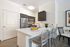 Modern kitchen with sleek stainless steel appliances, elegant countertops, and stylish seating area.