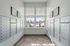Modern mailroom with sleek mailboxes and large windows offering natural light and a view of a snowy landscape.