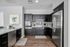 Modern kitchen with sleek dark cabinetry, stainless steel appliances, and elegant marble countertops, perfect for culinary creativity.