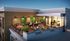 Chic rooftop terrace featuring lush green walls and stylish seating area for social gatherings.
