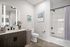 Elegant modern bathroom with sleek vanity, stylish wall art, and a chic shower curtain for a sophisticated look.