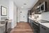 Modern kitchen with sleek stainless steel appliances, elegant cabinetry, and a cozy breakfast nook with bar stools.