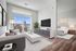 Modern apartment living room with stylish decor, large TV, and bright natural light from balcony. Cozy bedroom glimpsed through open doorway.