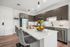 Modern kitchen with sleek cabinetry, stainless steel appliances, and a stylish island featuring elegant bar seating, perfect for entertaining.