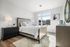 Bright and airy bedroom with modern decor, featuring a luxurious bed, elegant nightstands, and a large window providing natural light.