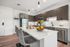 Modern kitchen with sleek cabinetry, stainless steel appliances, and elegant pendant lighting over a spacious island with seating.