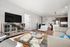 Modern open-plan living space with a sleek kitchen, cozy living area, and vibrant accents ideal for stylish urban living.