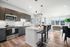 Modern kitchen and living area with sleek cabinetry, stylish breakfast bar, and large windows offering abundant natural light.