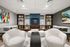 Elegant lounge area featuring modern armchairs, abstract artwork, and a sleek fireplace, perfect for relaxing in style.