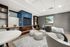 Chic apartment lounge featuring modern seating, stylish decor, and a cozy fireplace with vibrant artwork on the wall.