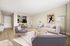 Elegant open-plan living room with modern furniture, bright natural light, and stylish dining area adjacent to a sleek kitchen.