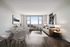 Modern and inviting living and dining area with sleek furniture, stylish decor, and large window offering breathtaking views.