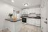 Bright, modern kitchen with sleek white cabinetry, stylish countertops, and stainless steel appliances.