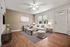 Bright and airy living room with elegant decor, featuring a comfortable white sofa, modern coffee table, and large windows providing natural light.